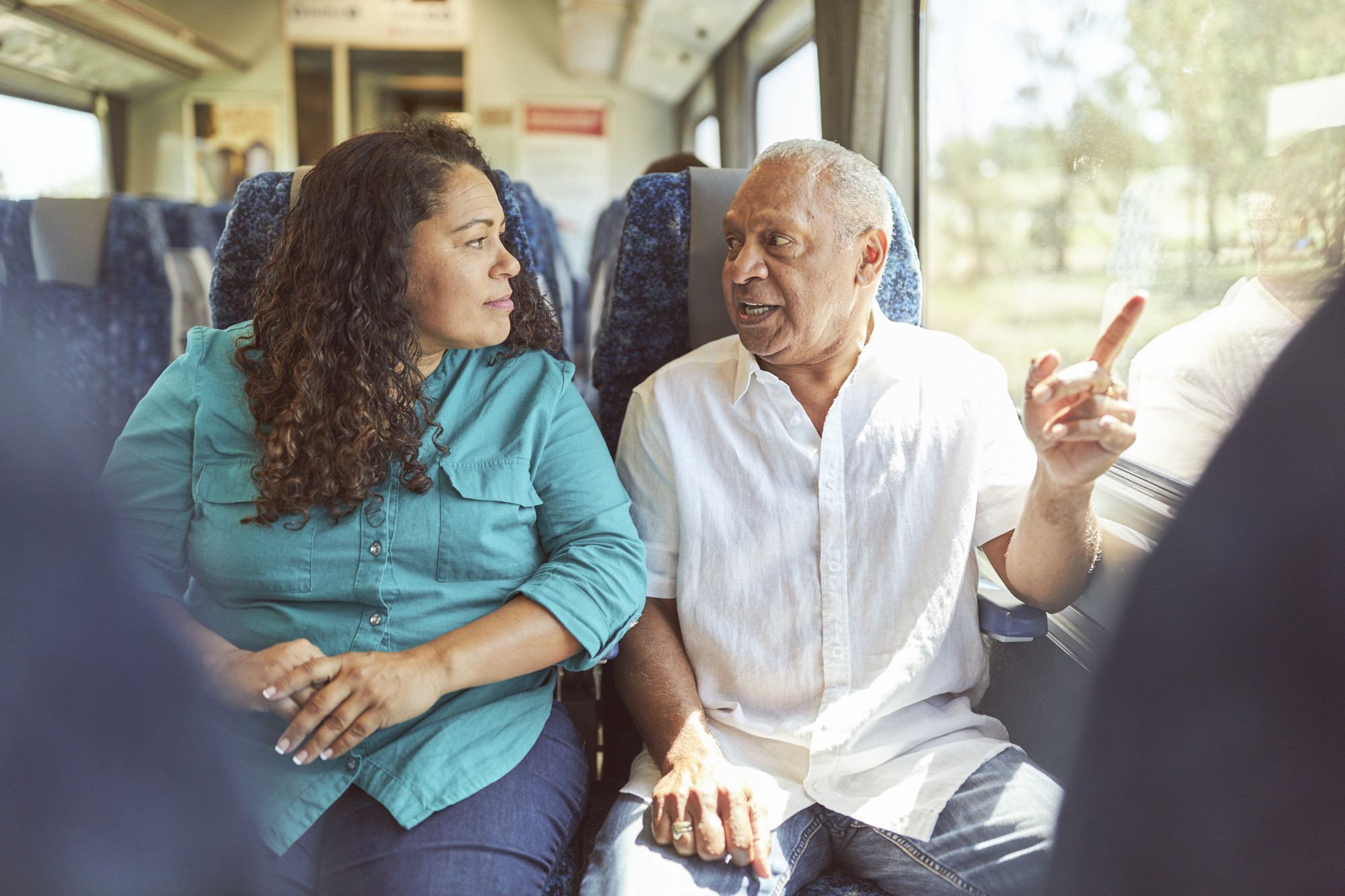 Two people chatting on the train.