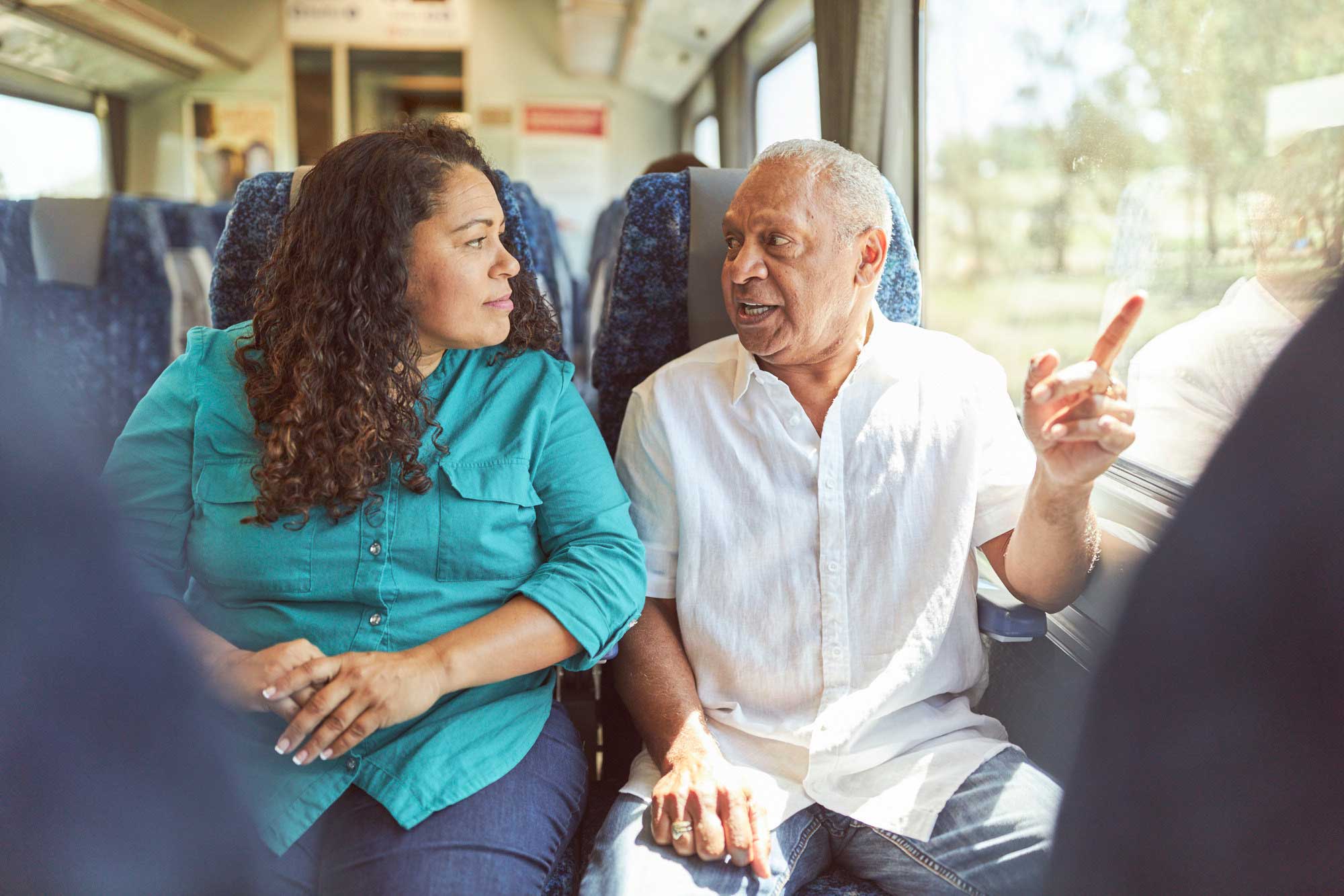 Two people chatting on the train.