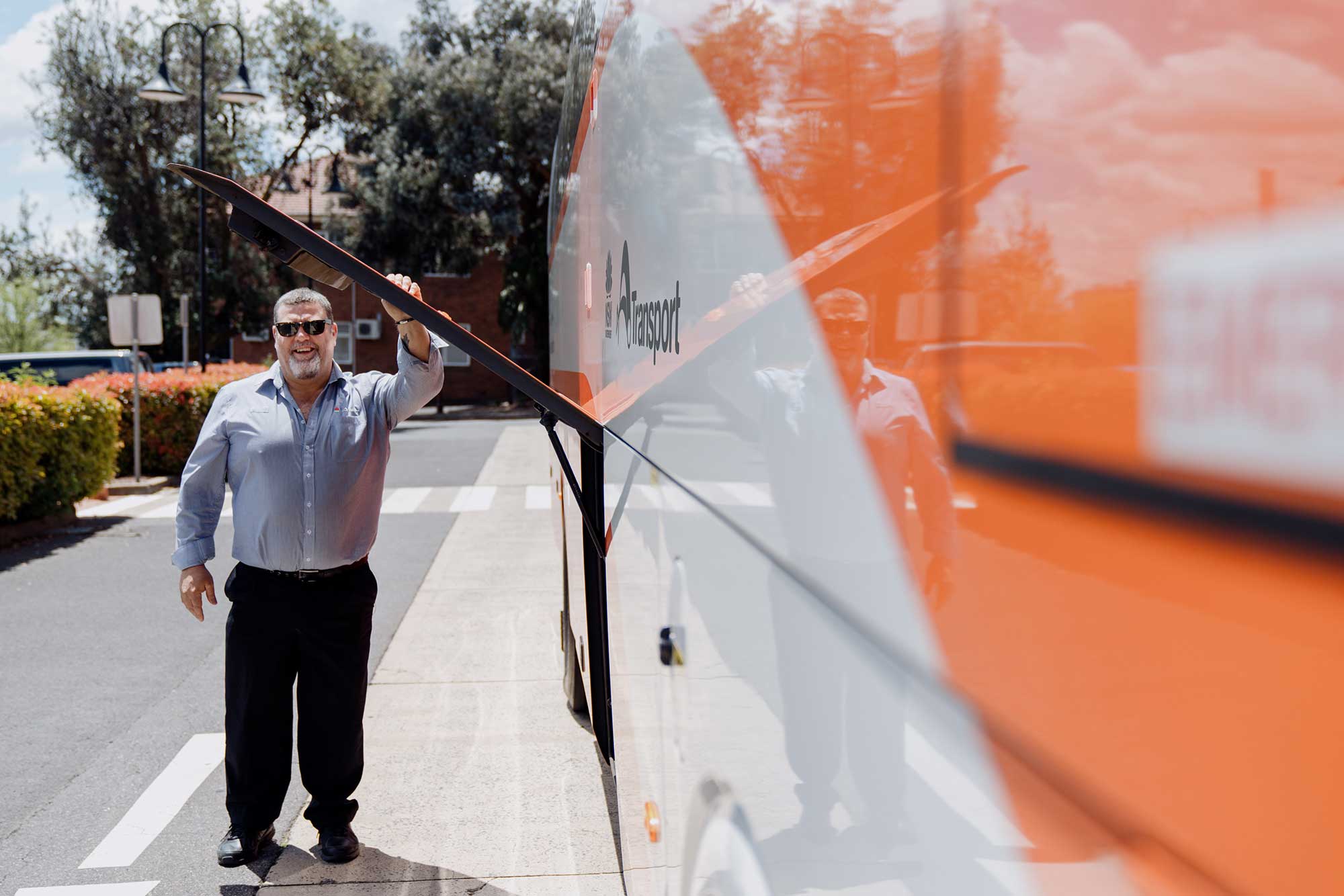Driver standing outside of coach.