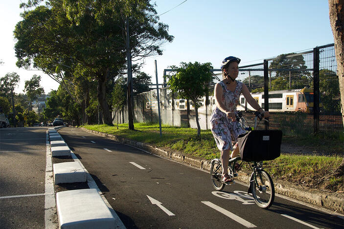 Woman rides bike along cycling route