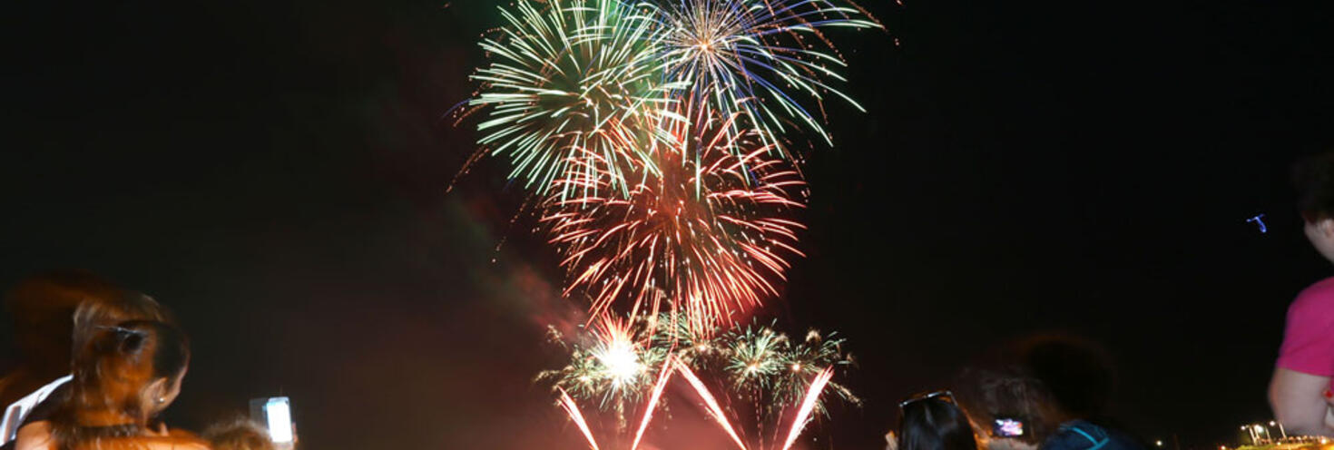 Fire works in colours of green and pink exploding over the top of Wollongong Harbour.