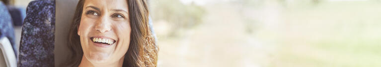 Woman on train, smiling