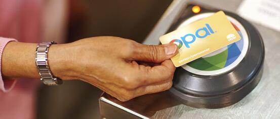 female hand tapping gold senior pensioner opal card