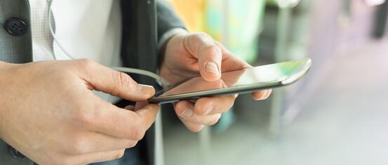 Person holding phone suing On Demand transport apps